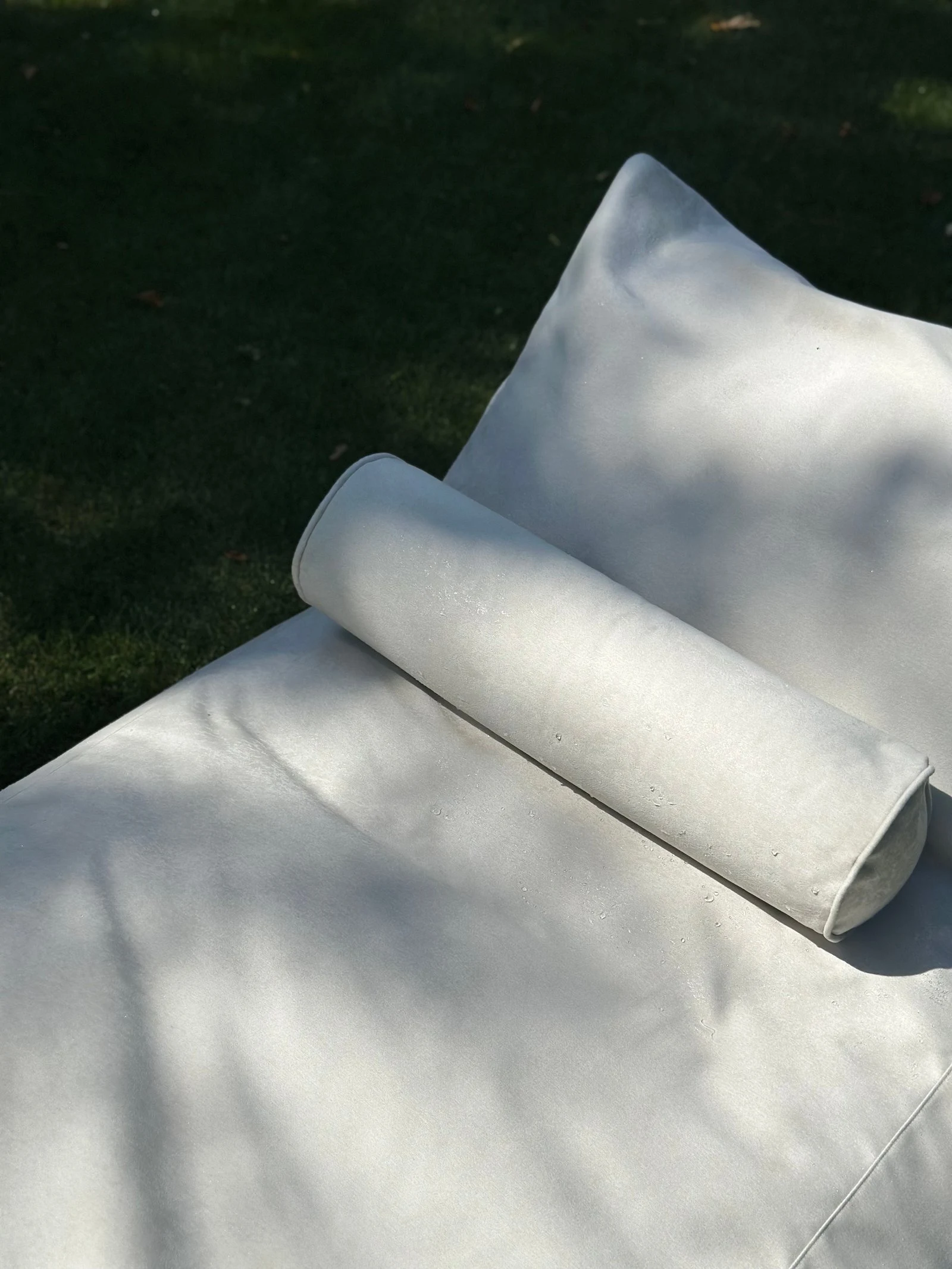 Side view of the Marolla lounger showing the soft bolster and floor-cushion form