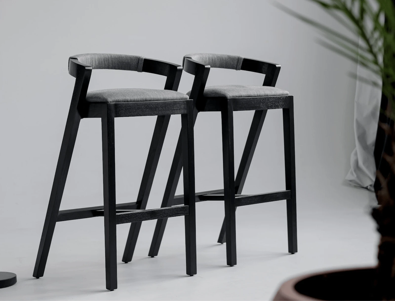 Two Baffi bar stools photographed in a clean studio on white floor