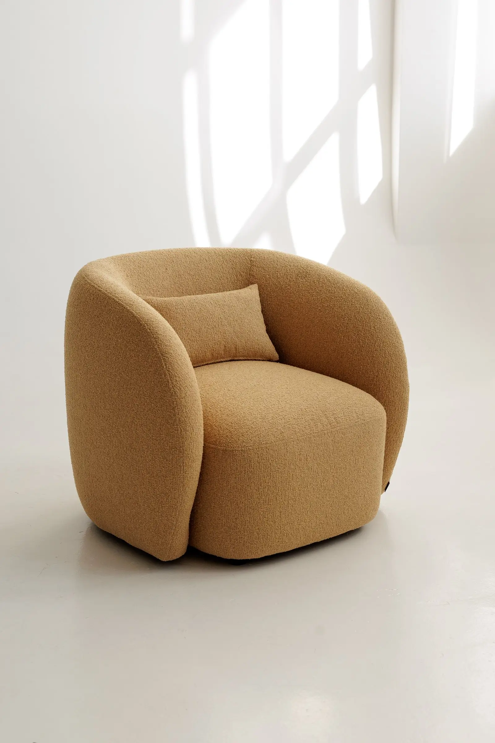 Mustard Everest 103 boucle Nuba armchair photographed in a bright studio