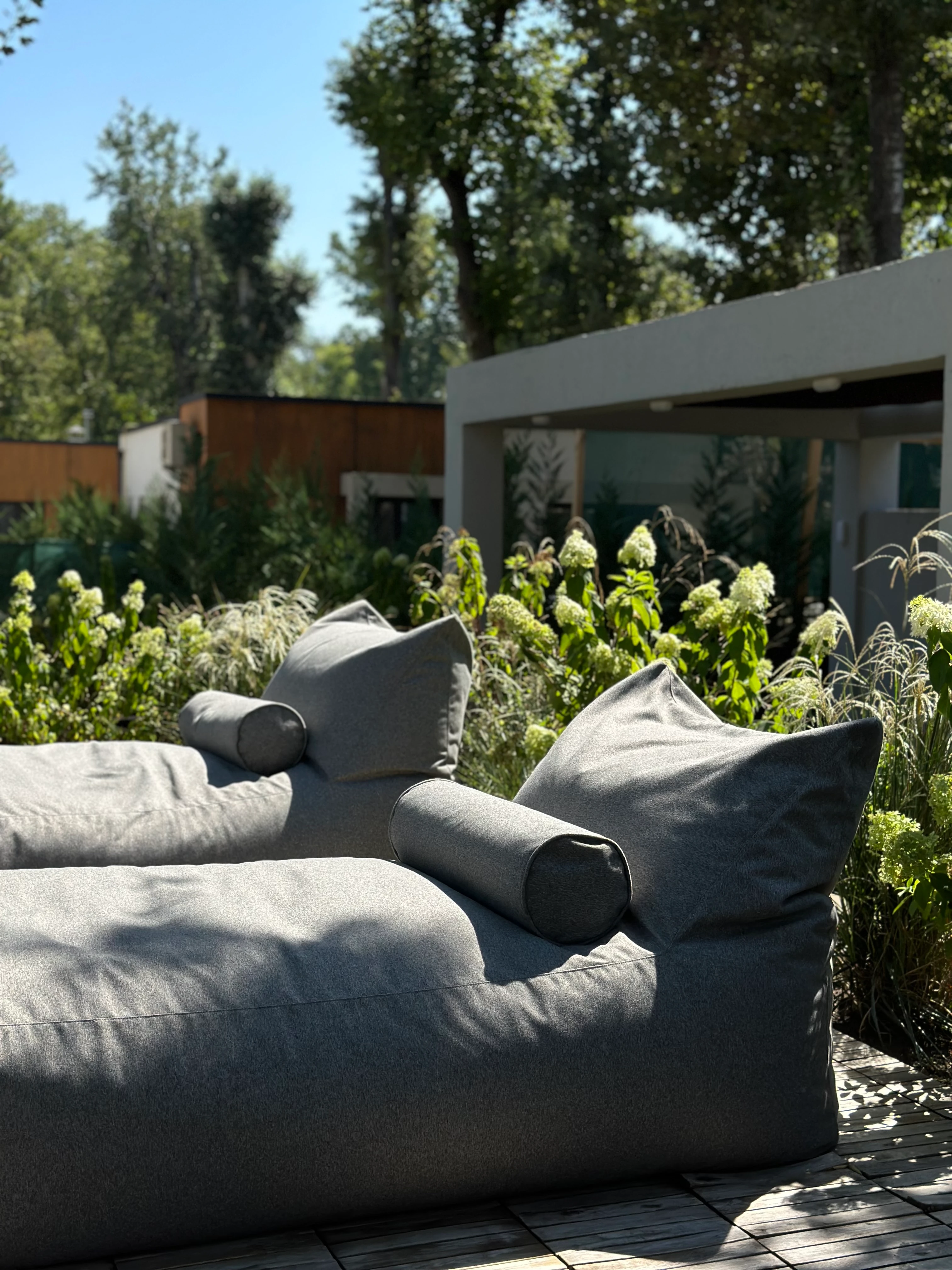Two deep-grey Marolla loungers on a garden deck