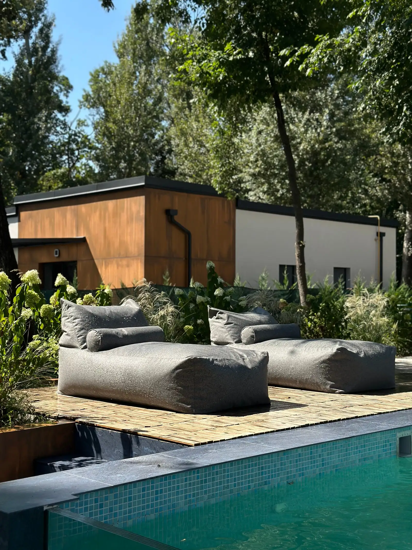Deep-grey Marolla loungers beside a villa pool