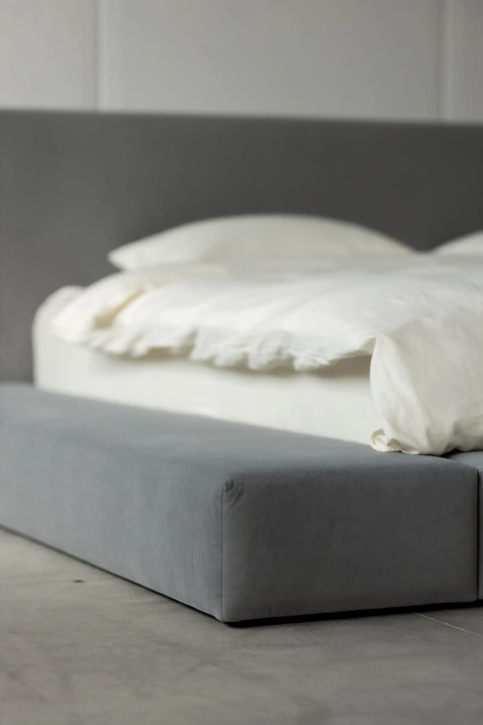 Close detail of the grey velvet Connect bumper meeting the bed body