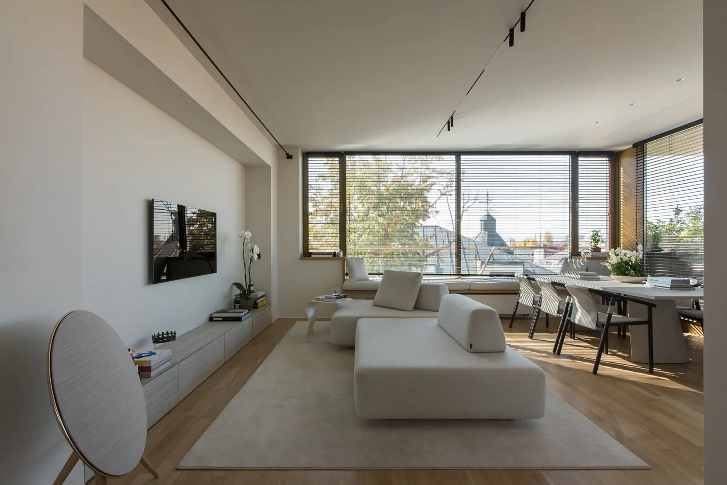 Cream Deseda in a real apartment with city views through grid-paned windows
