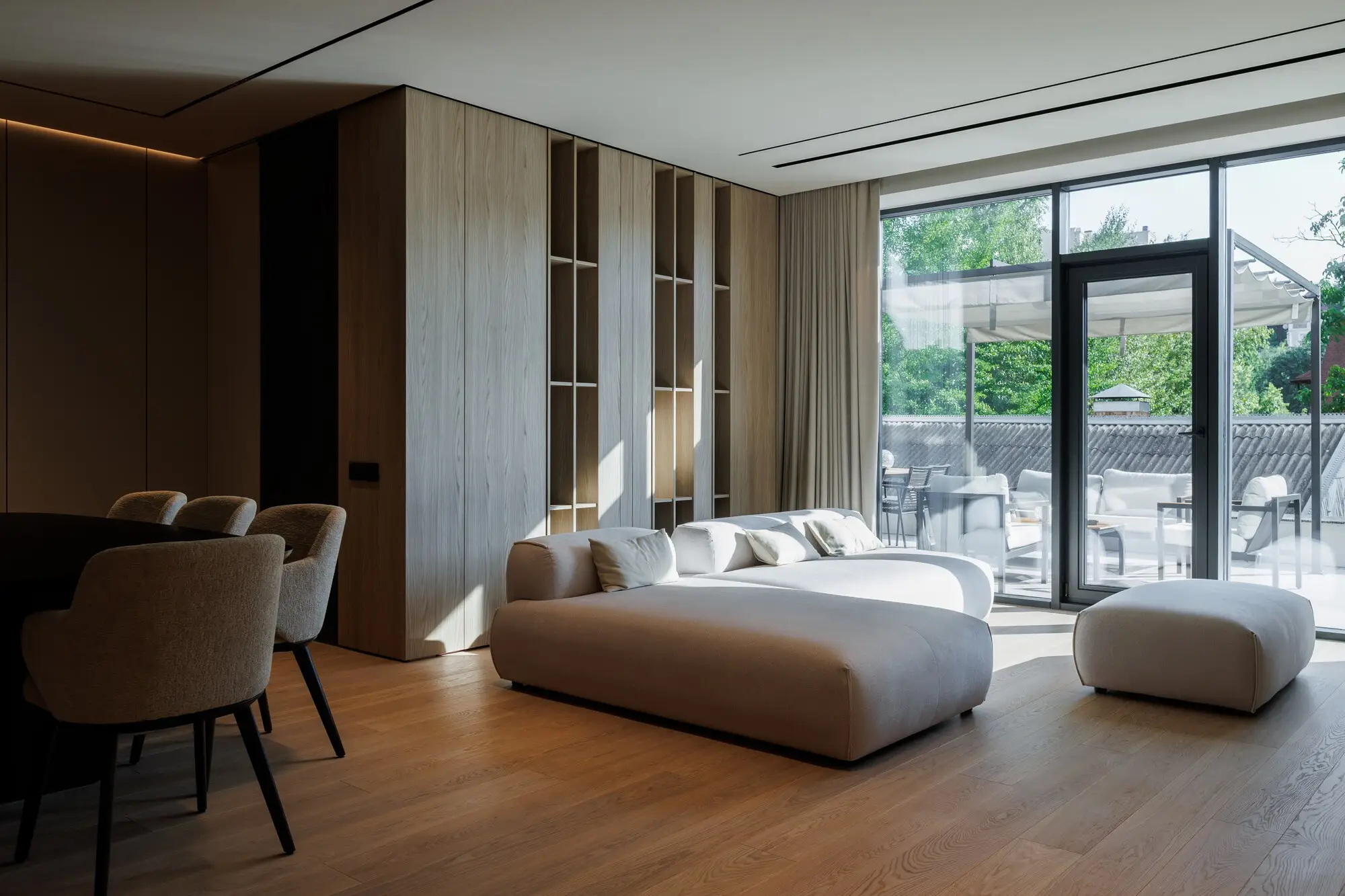 Cream Nissa facing a tall garden window with a covered terrace beyond