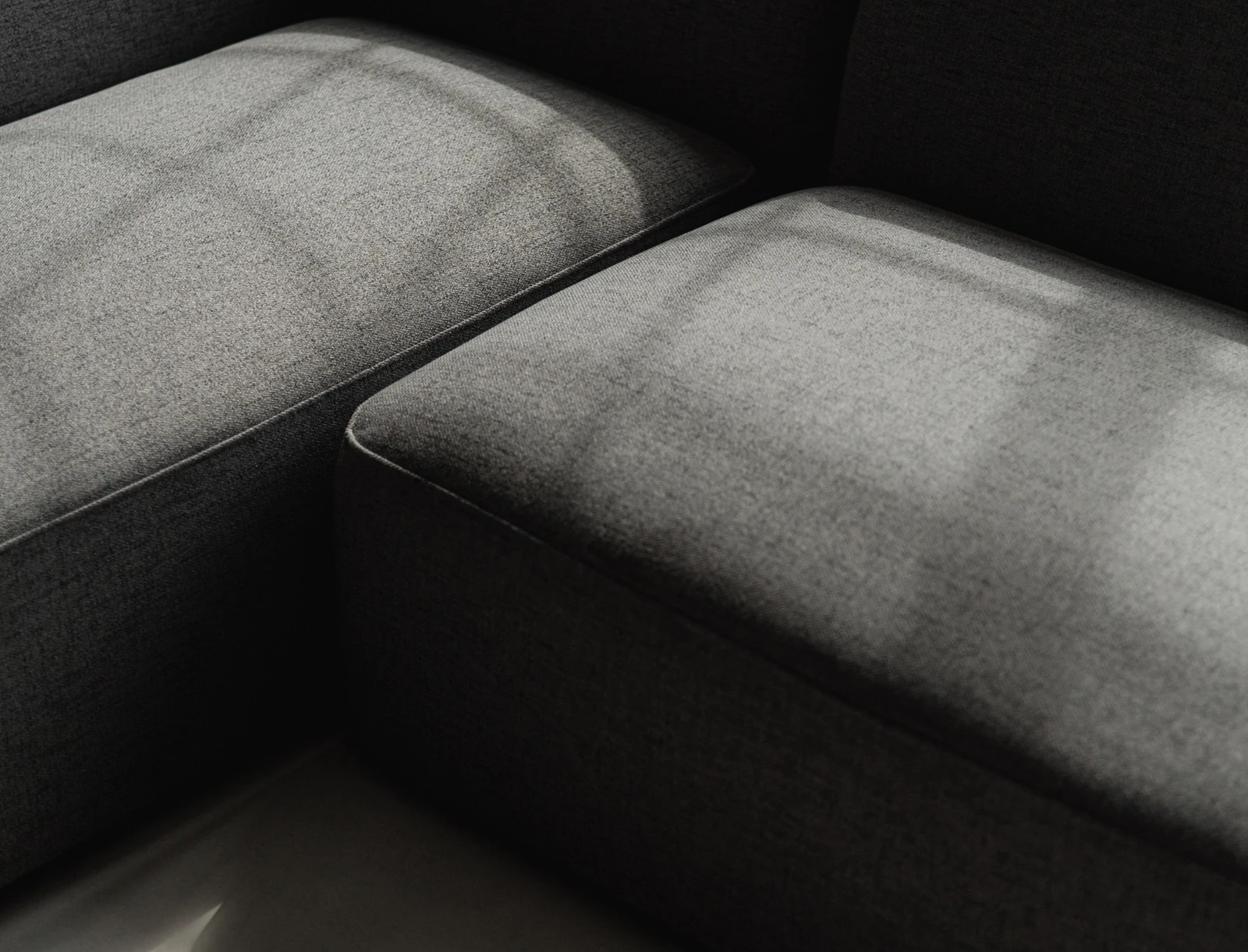 Close detail of two grey Kingston modules with light raking across the fabric seam