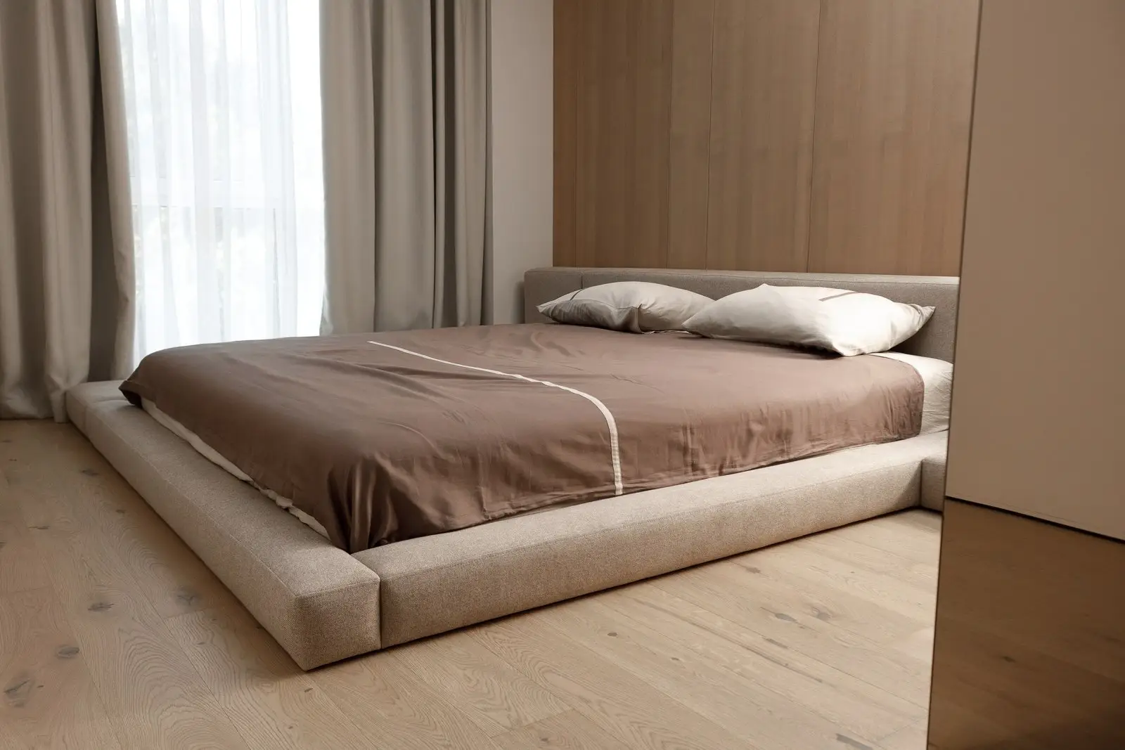Sand Soho 902 Connect bed in a wood-paneled bedroom with the L-shape bench extension on the right